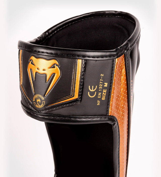 Protège-tibias Venum Elite Evo – Noir/Bronze – Protège-tibias