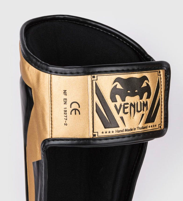 Espinilleras Venum Elite – Oro/Negro