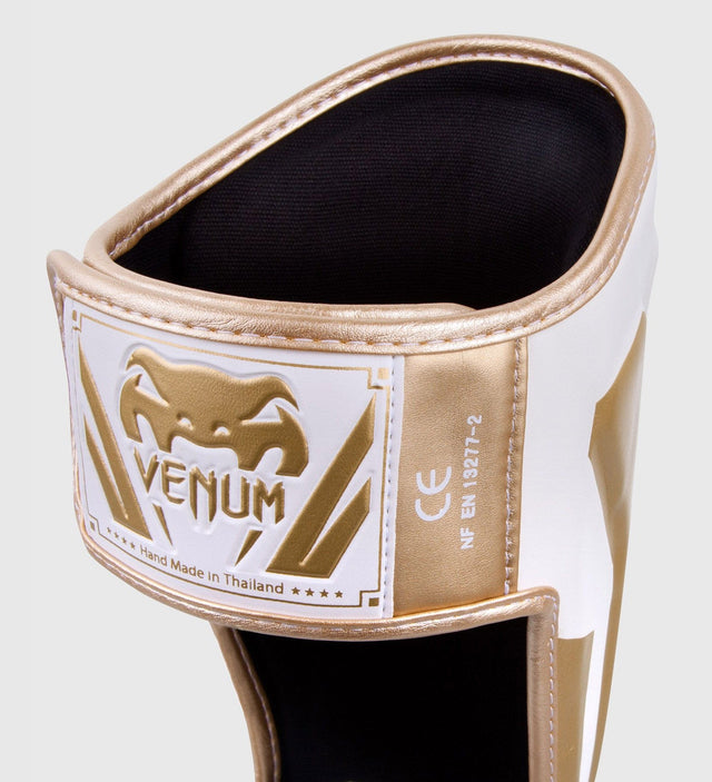 Espinilleras Venum Elite – Blanco/Oro
