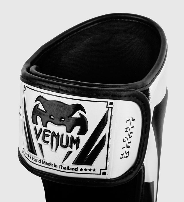 Espinilleras Venum Elite – Blanco/Negro