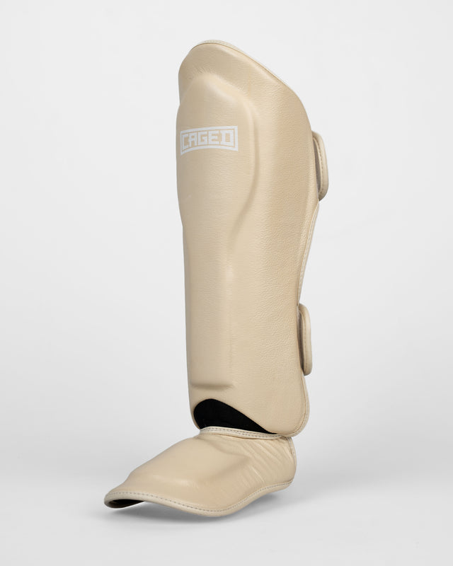 Espinilleras Caged 'X' Series – Blanco Crema