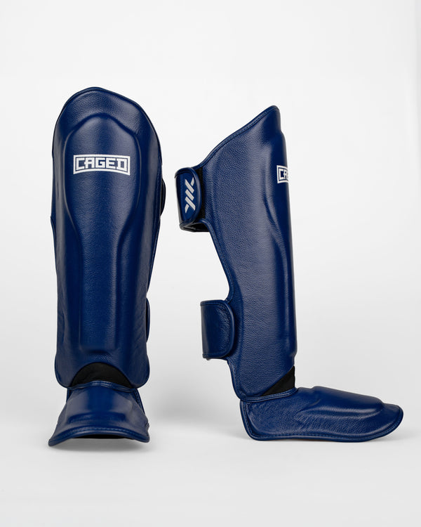 Espinilleras Caged 'X' Series – Azul marino/Blanco