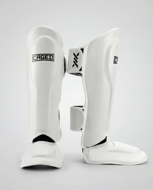 Espinilleras Caged 'X' Series – Blanco/Negro