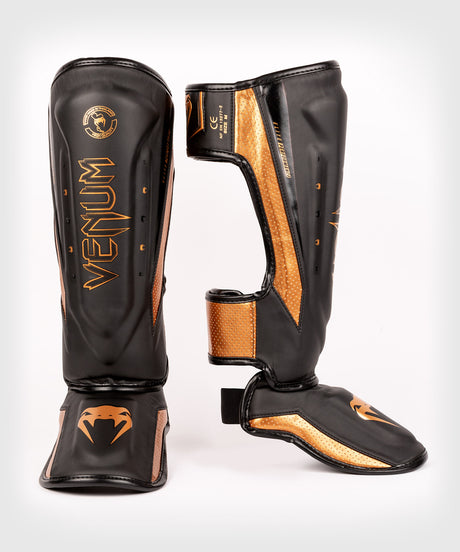 Espinilleras Venum Elite Evo – Negro/Bronce