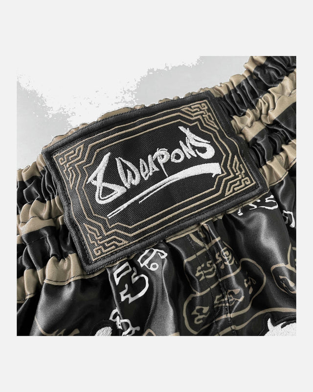 8 WEAPONS Muay-Thai-Shorts 8 Ways Yant 2.0 – Schwarz/Sand