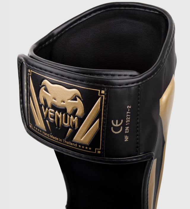Espinilleras Venum Elite – Negro/Oro